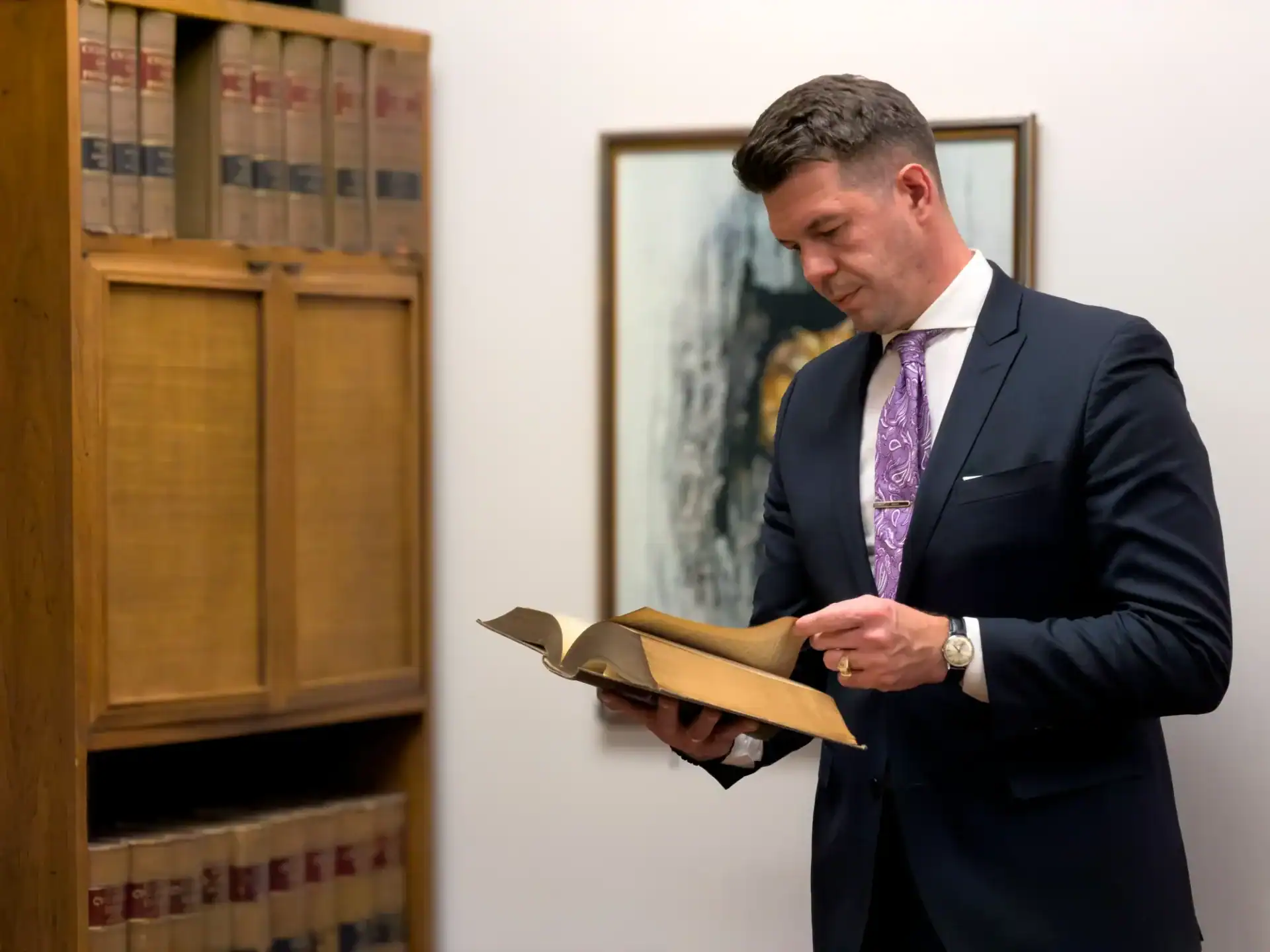 Borjan Kovacevic Criminal Defense Attorney reviewing law encyclopedia